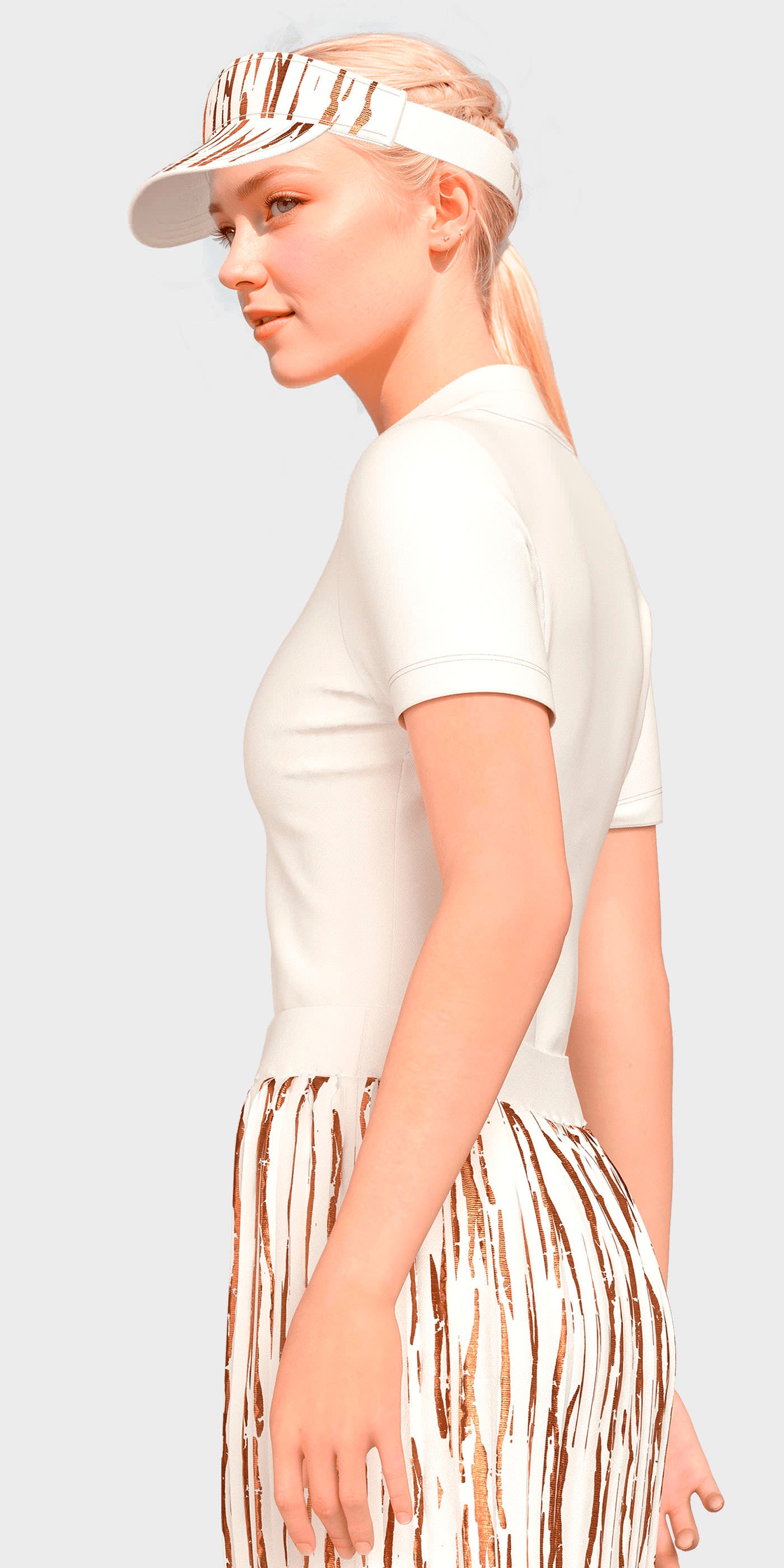Woman wearing a white t-shirt and patterned skirt with a visor on a light gray background
